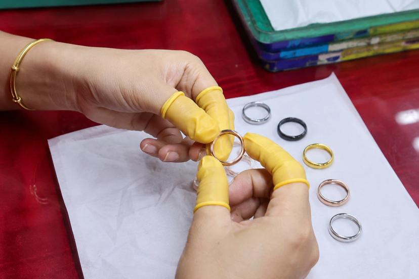 Quality fashion jewelry material and finish inspection showing rings in multiple metal colors