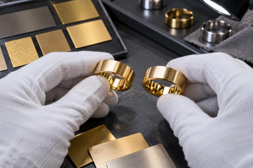 Gold PVD ring samples compared against finish references during color inspection